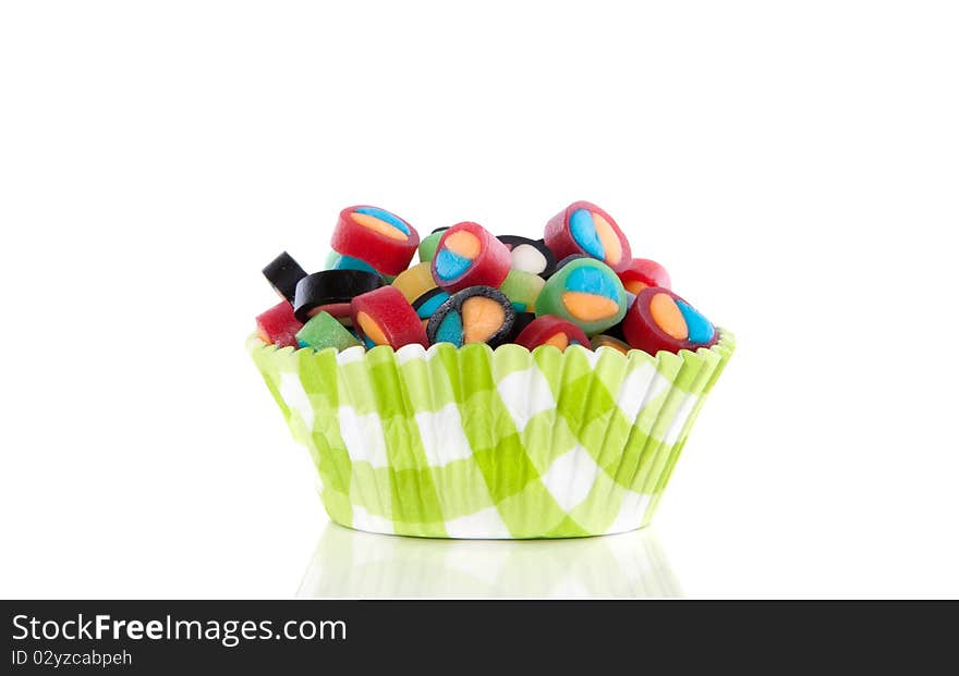 Colorful little candy in a modern cupake mold isolated over white. Colorful little candy in a modern cupake mold isolated over white