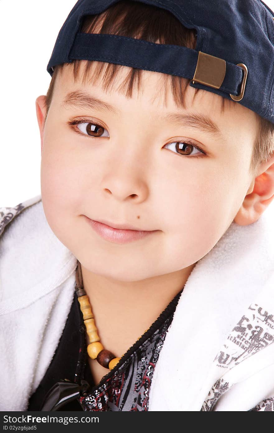 Close-up portrait of cute smiling boy on white background