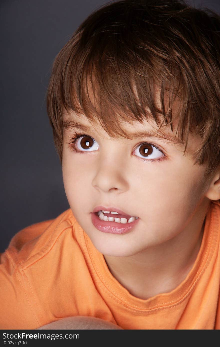 Close-up portrait of cute little boy looking up, studio shot. Close-up portrait of cute little boy looking up, studio shot