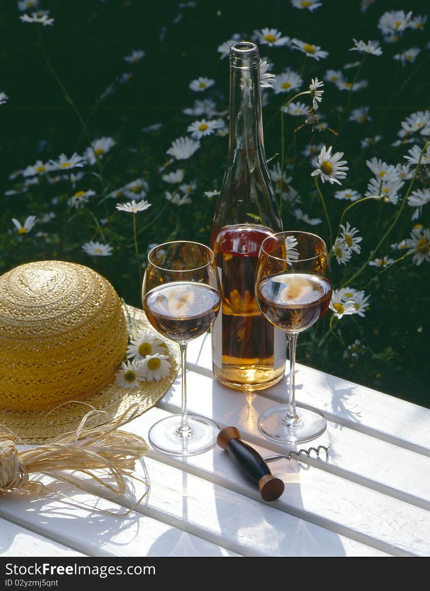 Glasses of rose wine with a hat on wooden table. Glasses of rose wine with a hat on wooden table