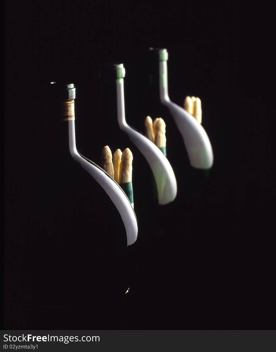 Bottle of wine with asparagus and black background