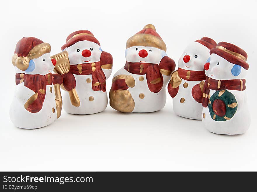 Figurines of snowmen on a white background. Figurines of snowmen on a white background