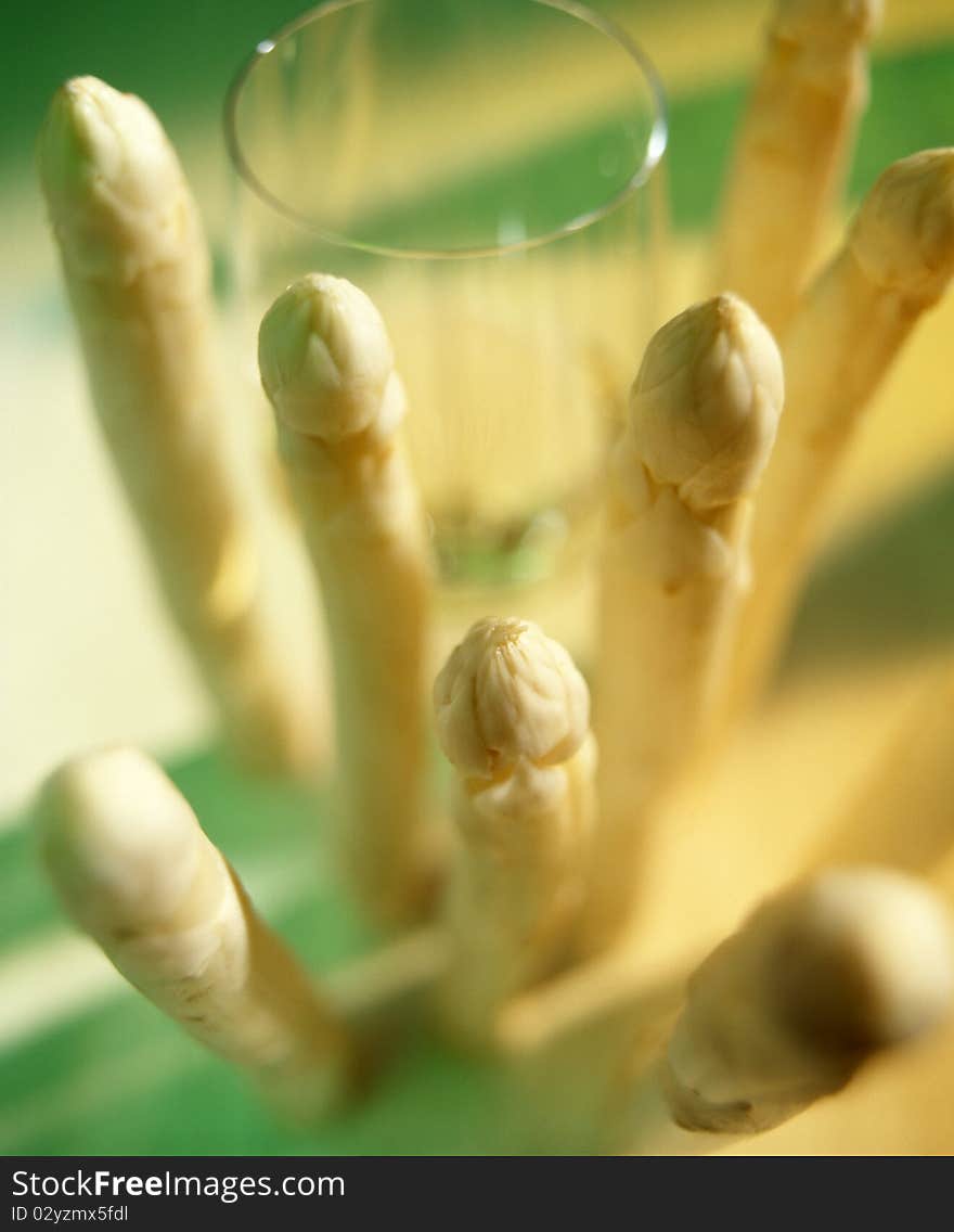 Glass of white wine with asparagus in an green and yellow ambiance