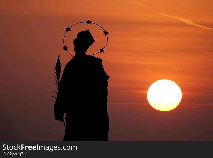 Statue of St John of Nepomuk in sunset