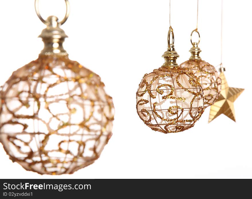 Golden christmas balls and gold star over white background.