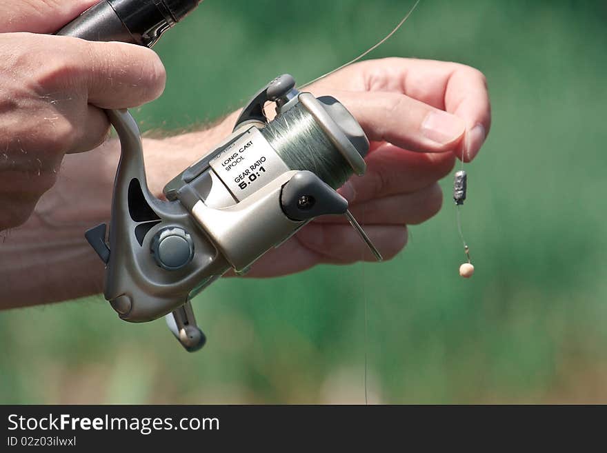 Closeup of a fisherman hand holding a fishing rod