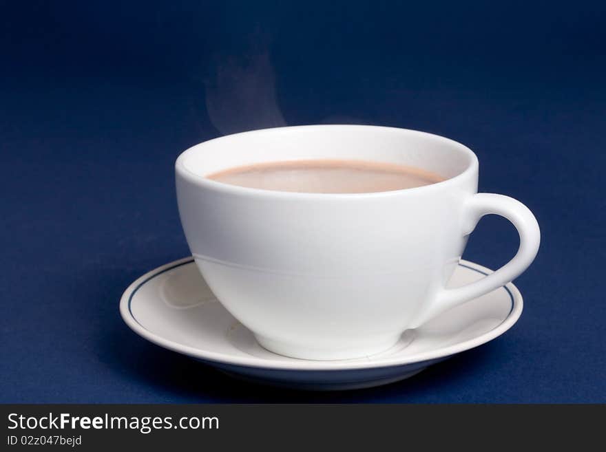 Steaming cup of hot cocoa on blue background. Steaming cup of hot cocoa on blue background