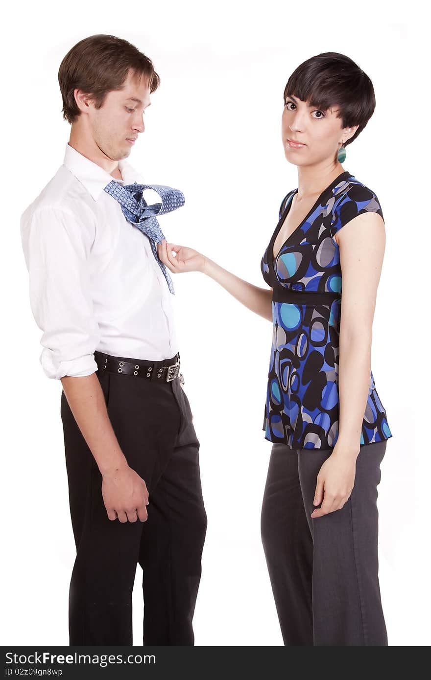 A woman looking at camera with a serious expression sick of trying to tie her man's tie. A woman looking at camera with a serious expression sick of trying to tie her man's tie.