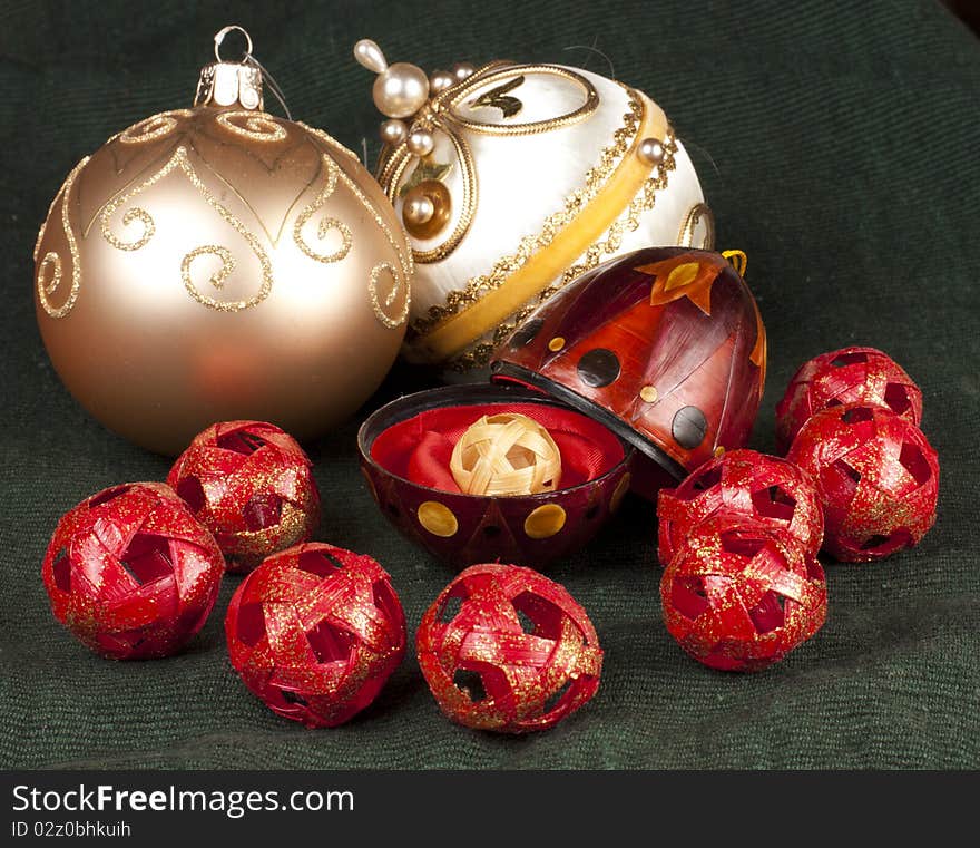 Open red ornament with gold ball