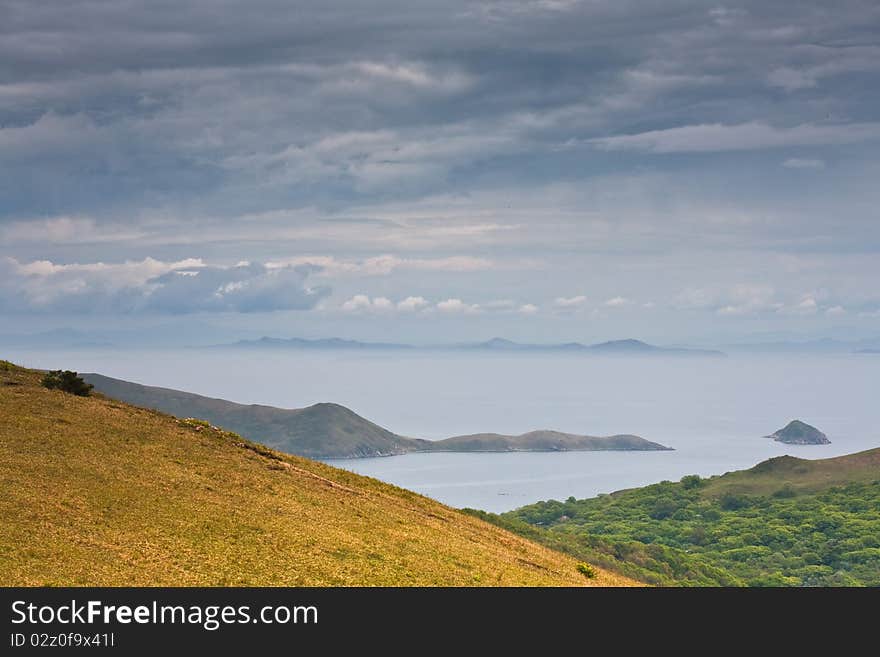 Russian Primorye seabank. near Vladivostok. Andreevka village.The mysterious island in the blue sea. Russian Primorye seabank. near Vladivostok. Andreevka village.The mysterious island in the blue sea