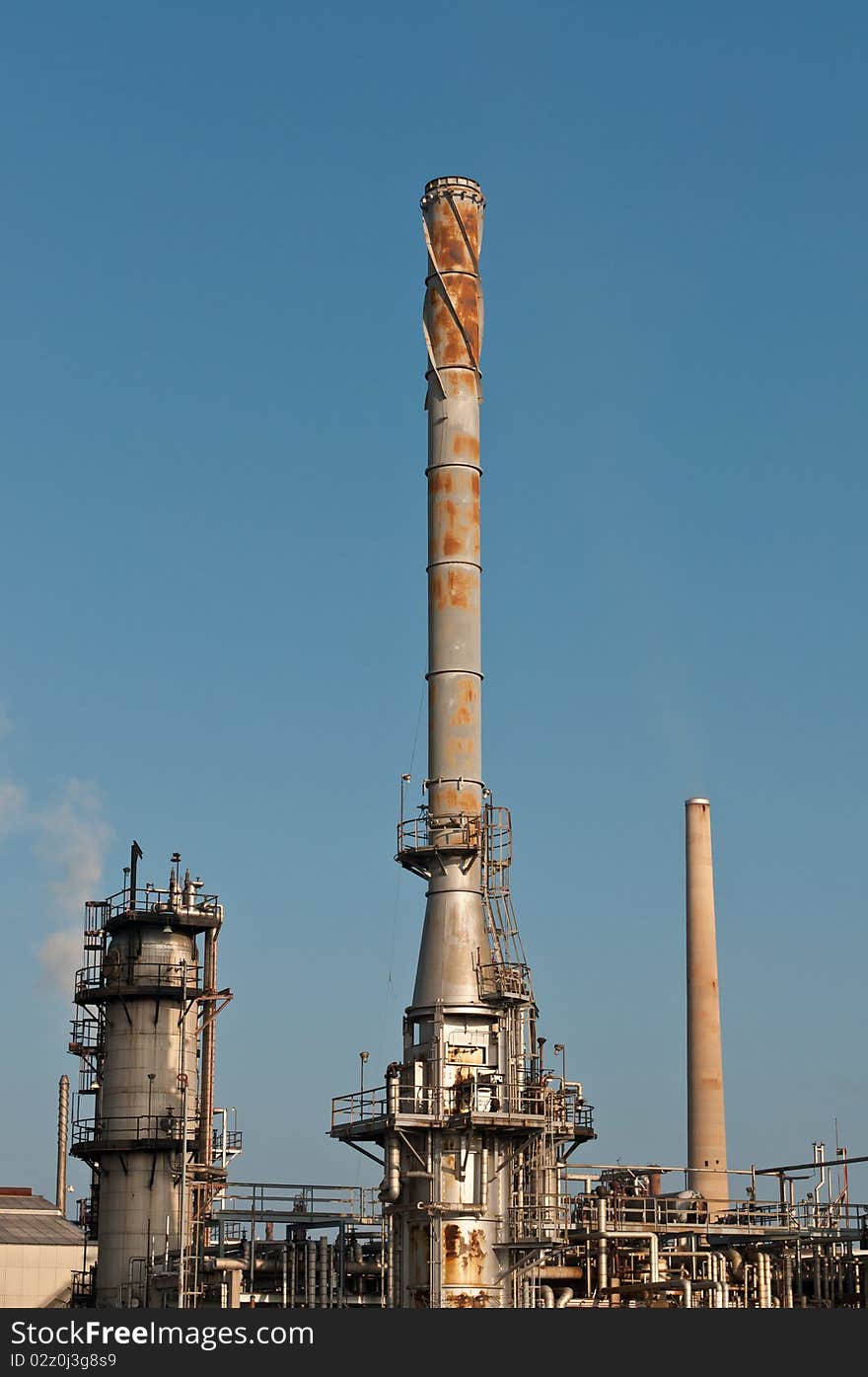 A petrochemical refinery plant with pipes and cooling towers.