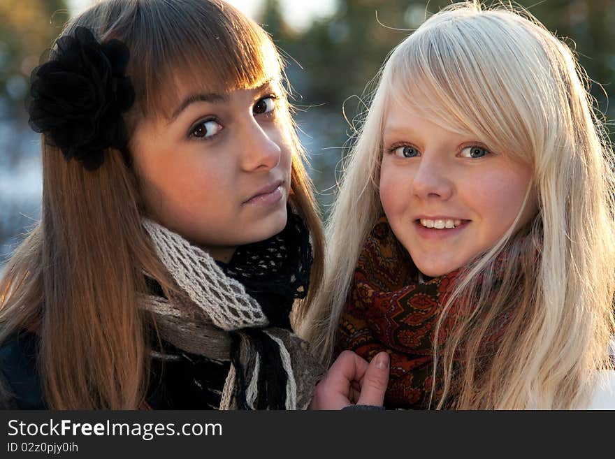 Portrait two young beautiful girls in wood