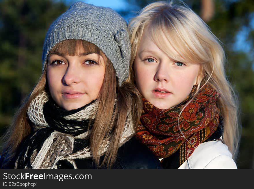 Portrait two young beautiful girls in wood