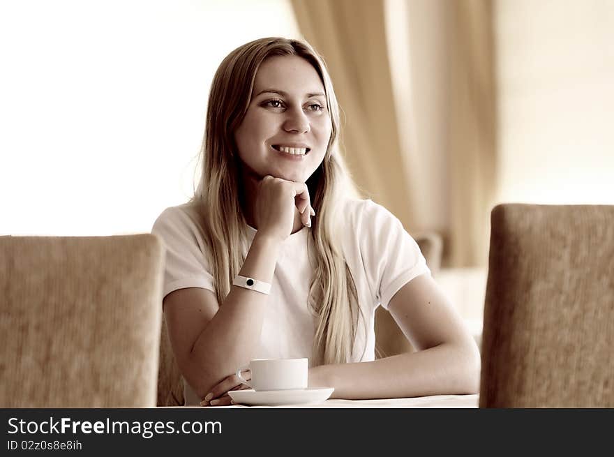 Happy woman in white with cup of coffee or tea. Happy woman in white with cup of coffee or tea.