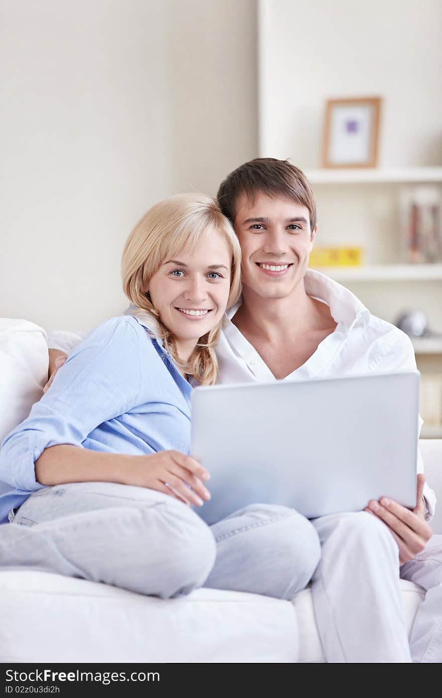 Young couple on the couch with a laptop. Young couple on the couch with a laptop