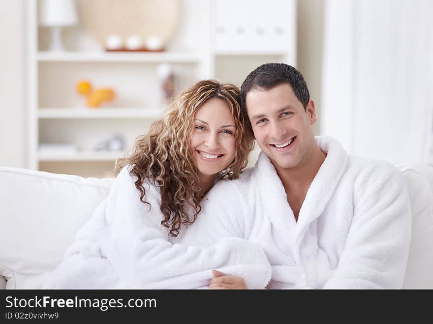 Laughing attractive couple in dressing gowns. Laughing attractive couple in dressing gowns