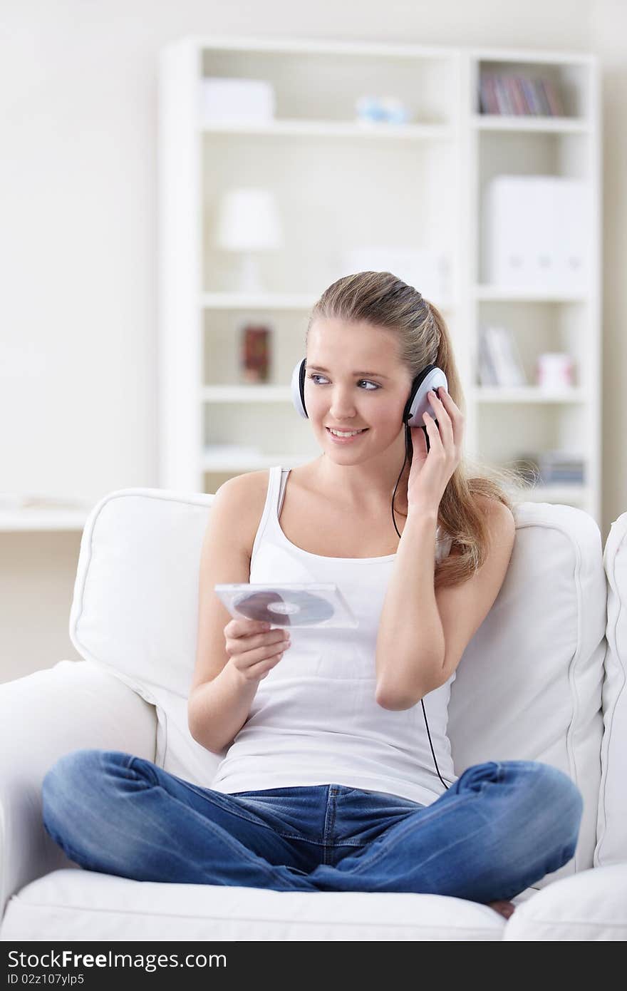 A young girl listens to music on headphones. A young girl listens to music on headphones