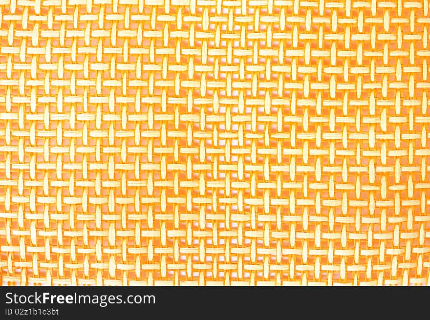 A close-up view of a yellow straw mat.