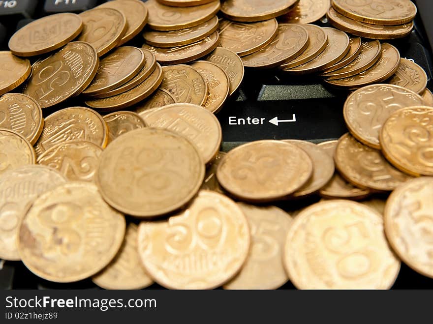 Heap of yellow coins on black keyboard. Heap of yellow coins on black keyboard