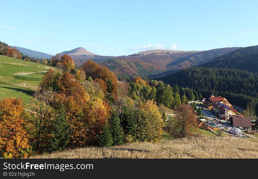 The mountain autumn landscape with colorful forest