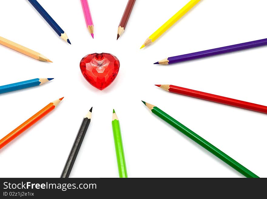 Red crystal heart surrounded with color pencil. Red crystal heart surrounded with color pencil