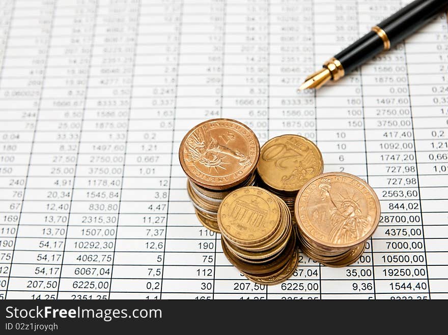 Financial document with numbers with coins stacks. Financial document with numbers with coins stacks