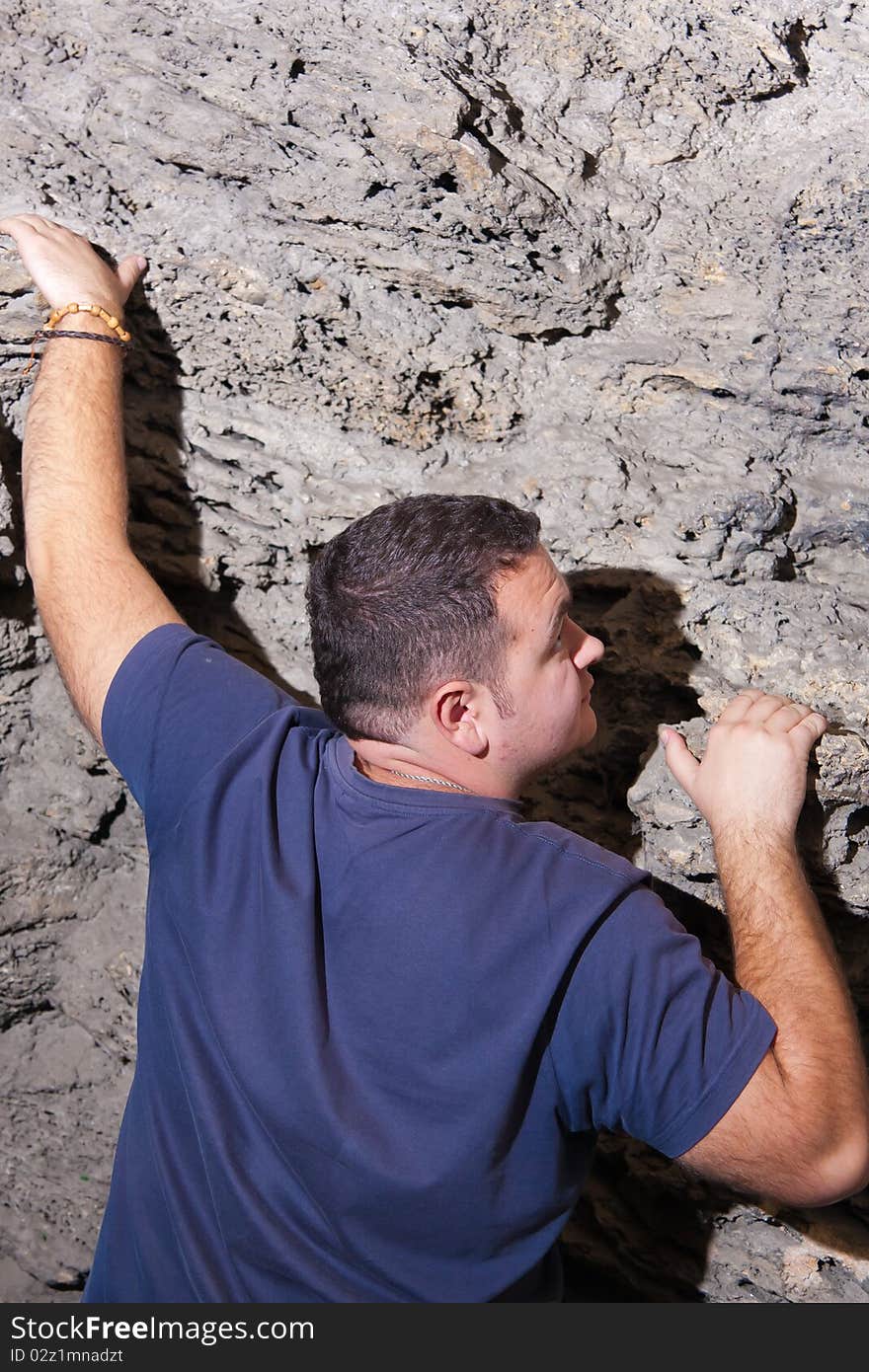 Portrait of a casual man climbing in a cave. Portrait of a casual man climbing in a cave