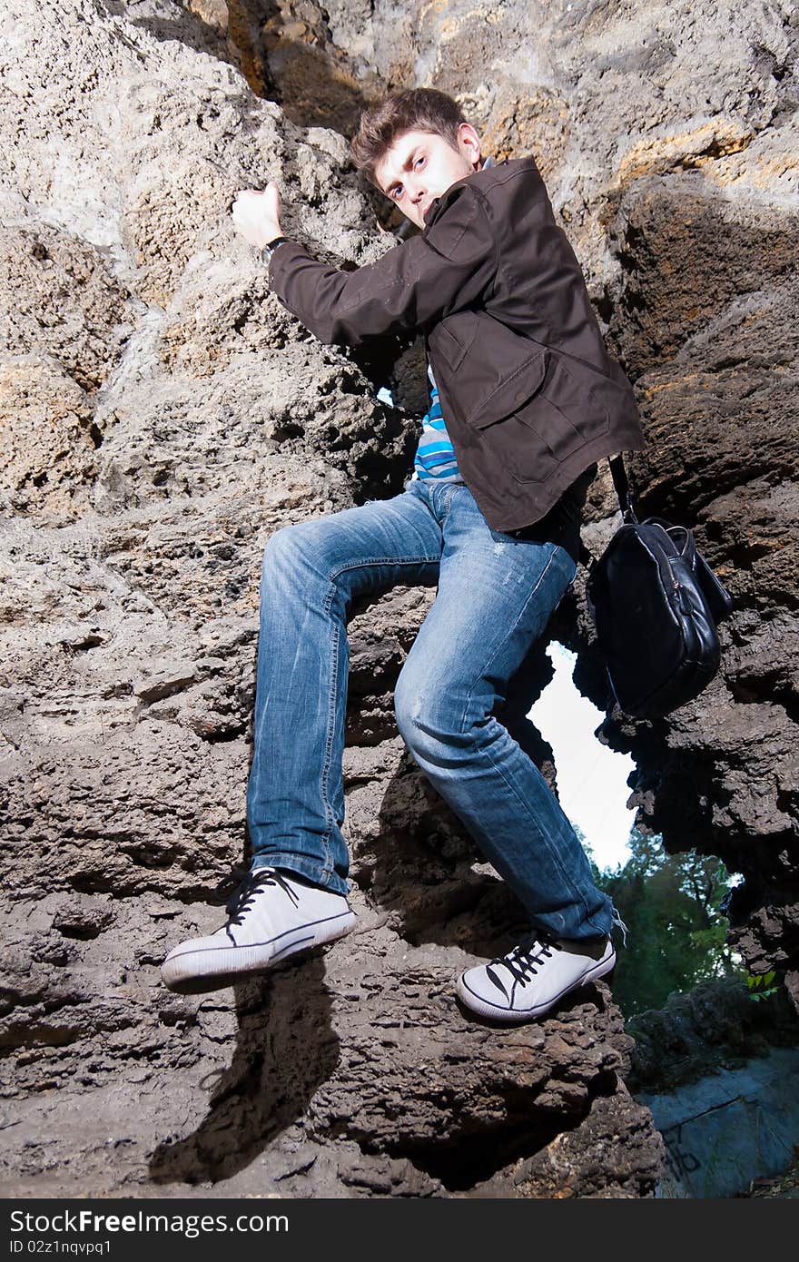 Portrait of a handsome man standing in cave and looking up. Portrait of a handsome man standing in cave and looking up