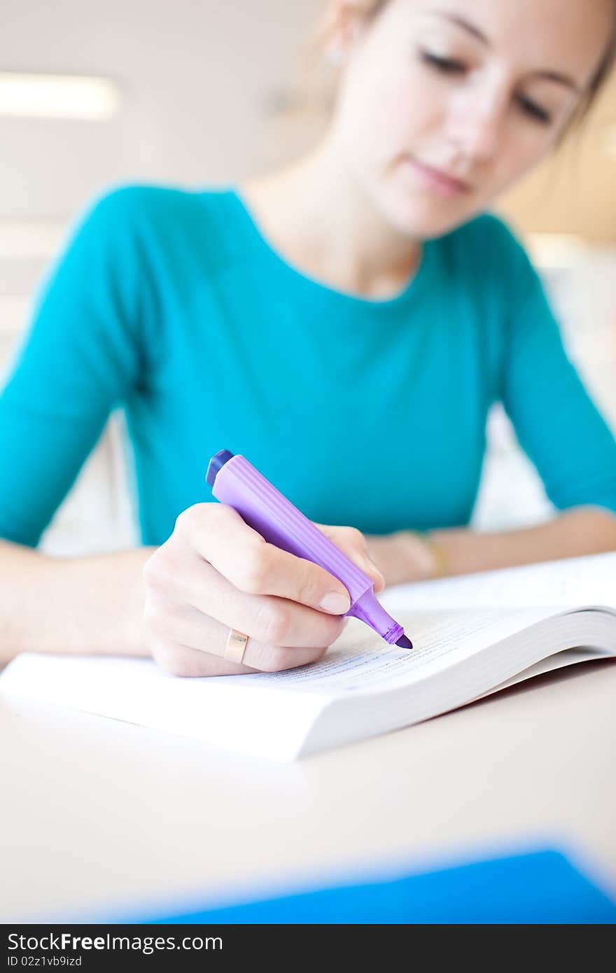 Pretty young college student in a library (shallow DOF; color toned image)