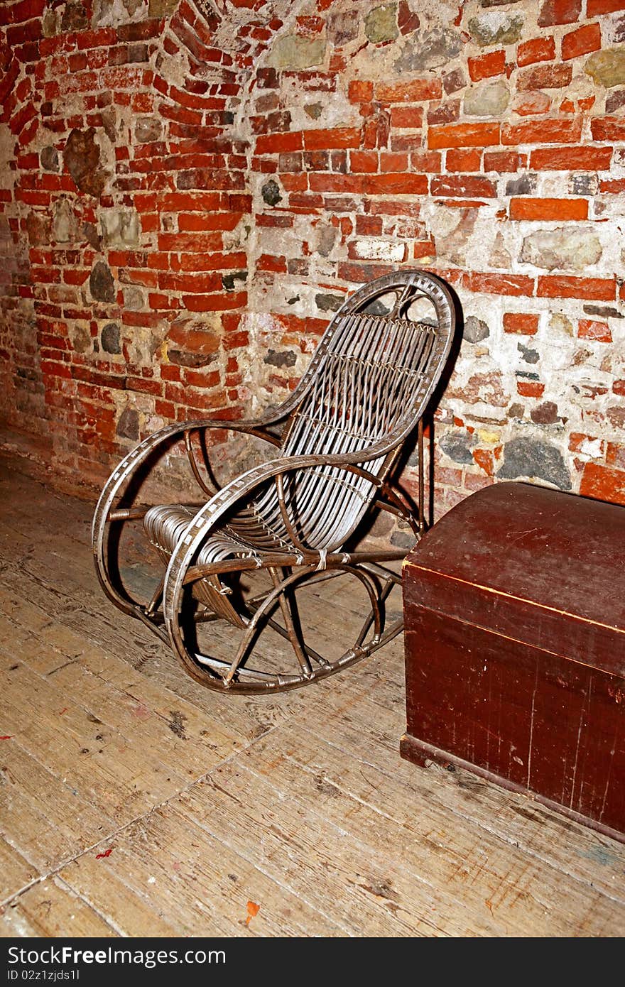 A old rocking chair and red wall