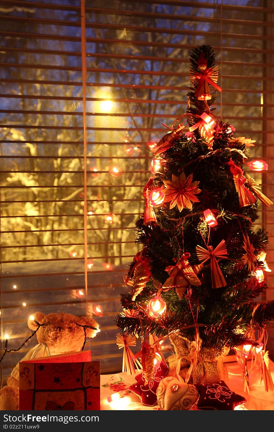 Christmas tree by the window with lights on