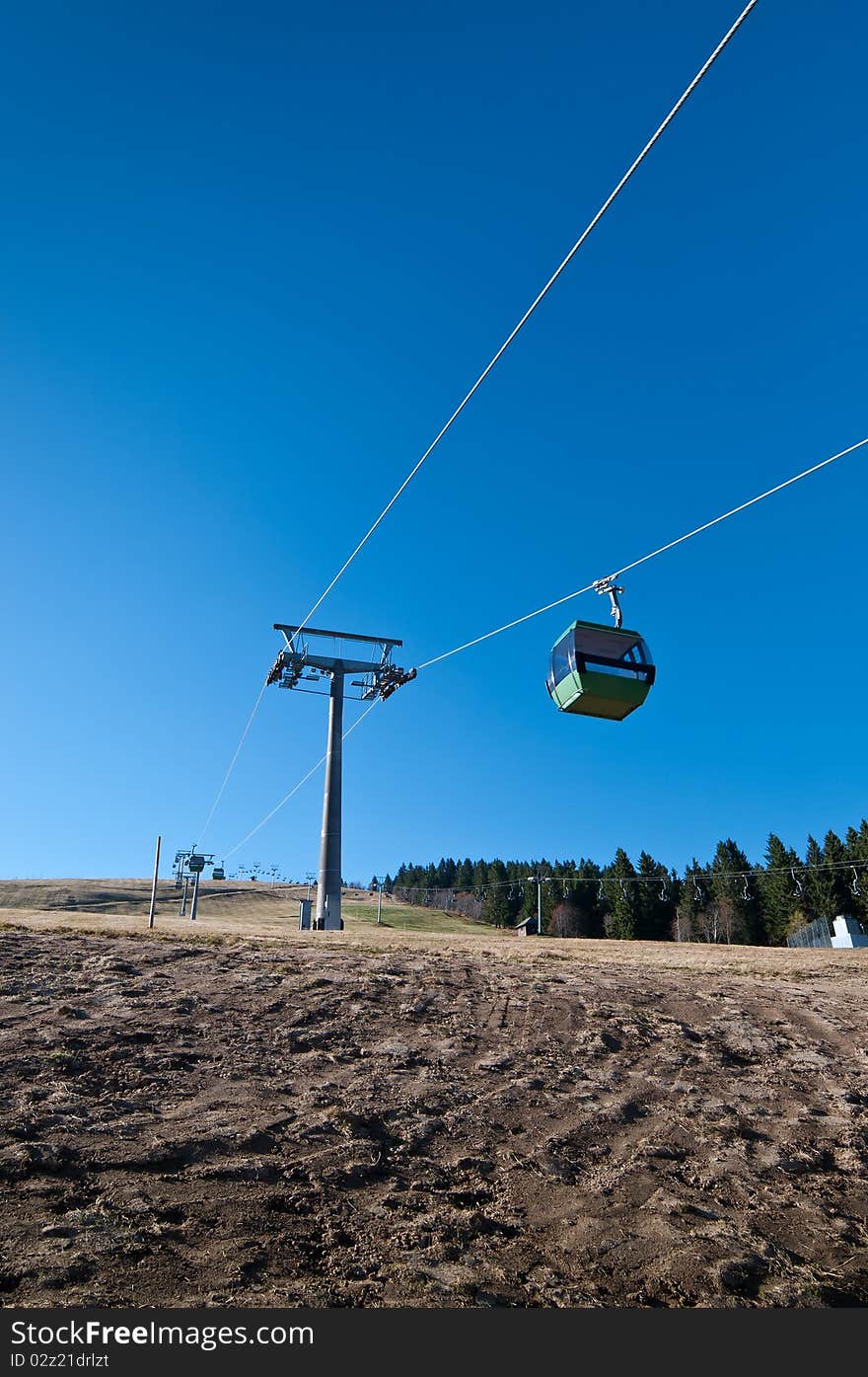 Cableway with no snow on mountain