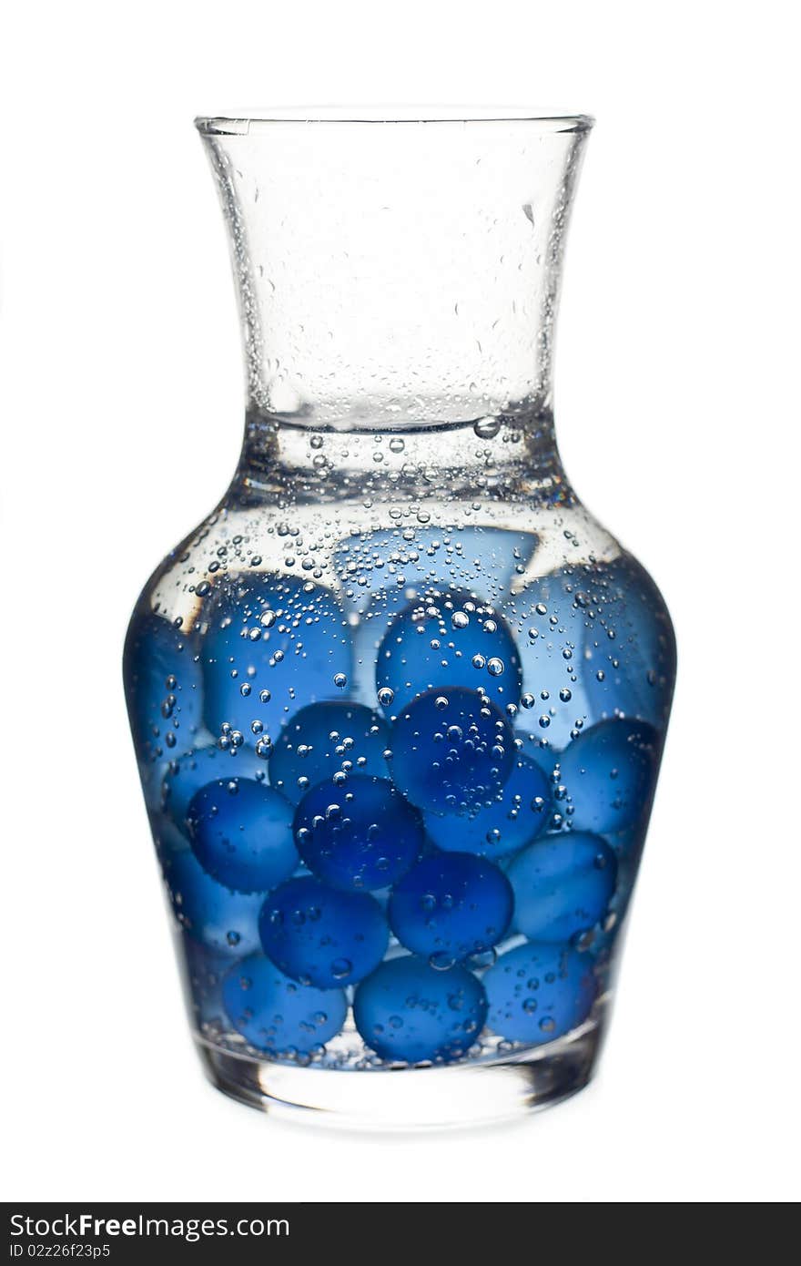 Laboratory glass full of blue marbles and water. Laboratory glass full of blue marbles and water