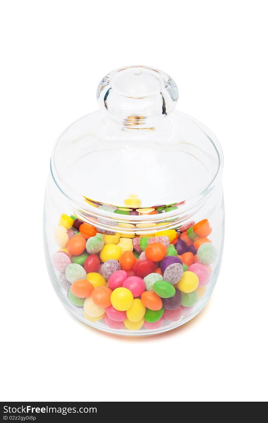 Candy in a glass jar on white background