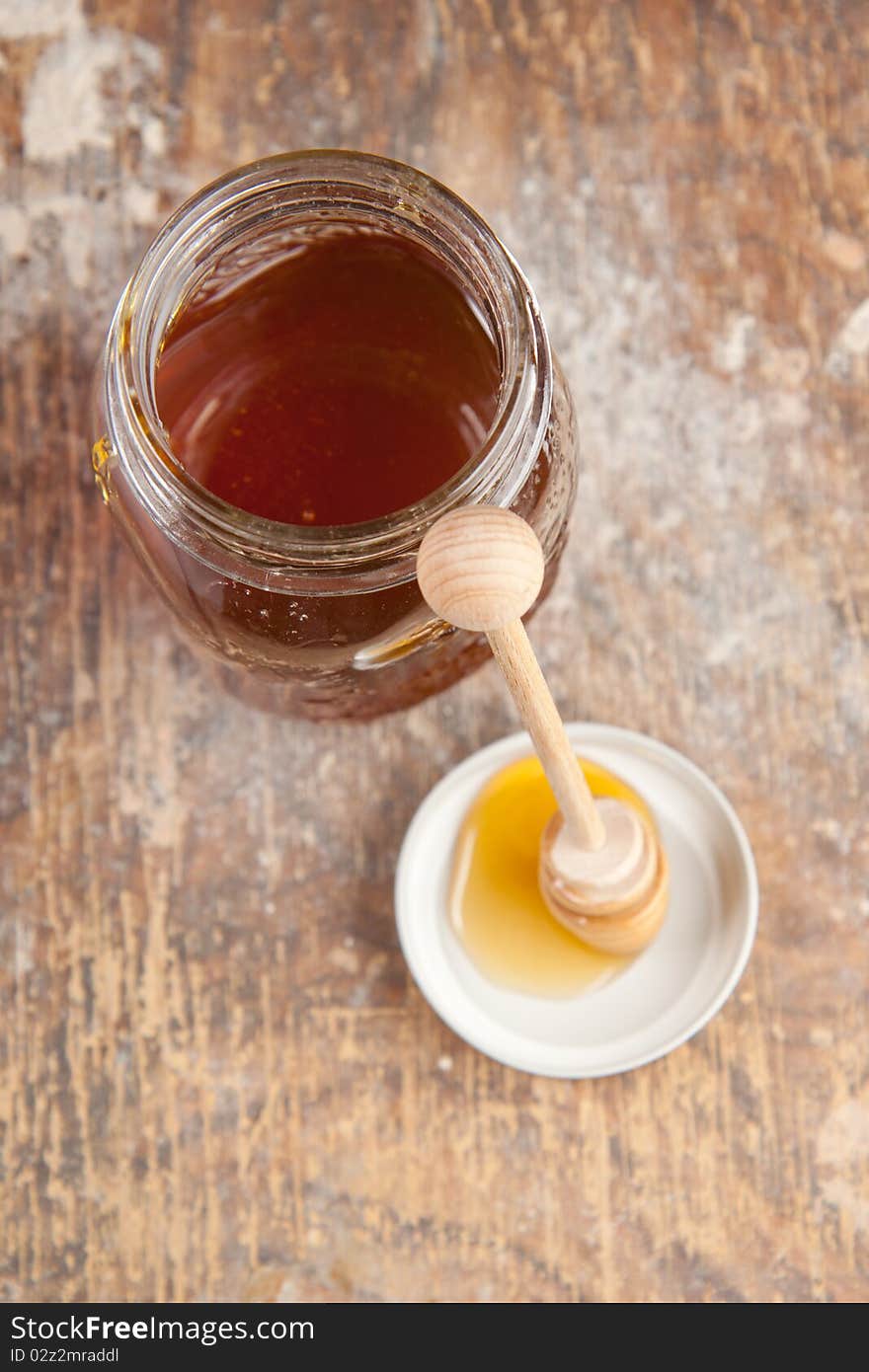 Glass pot of the fresh honey and honey drops. Glass pot of the fresh honey and honey drops