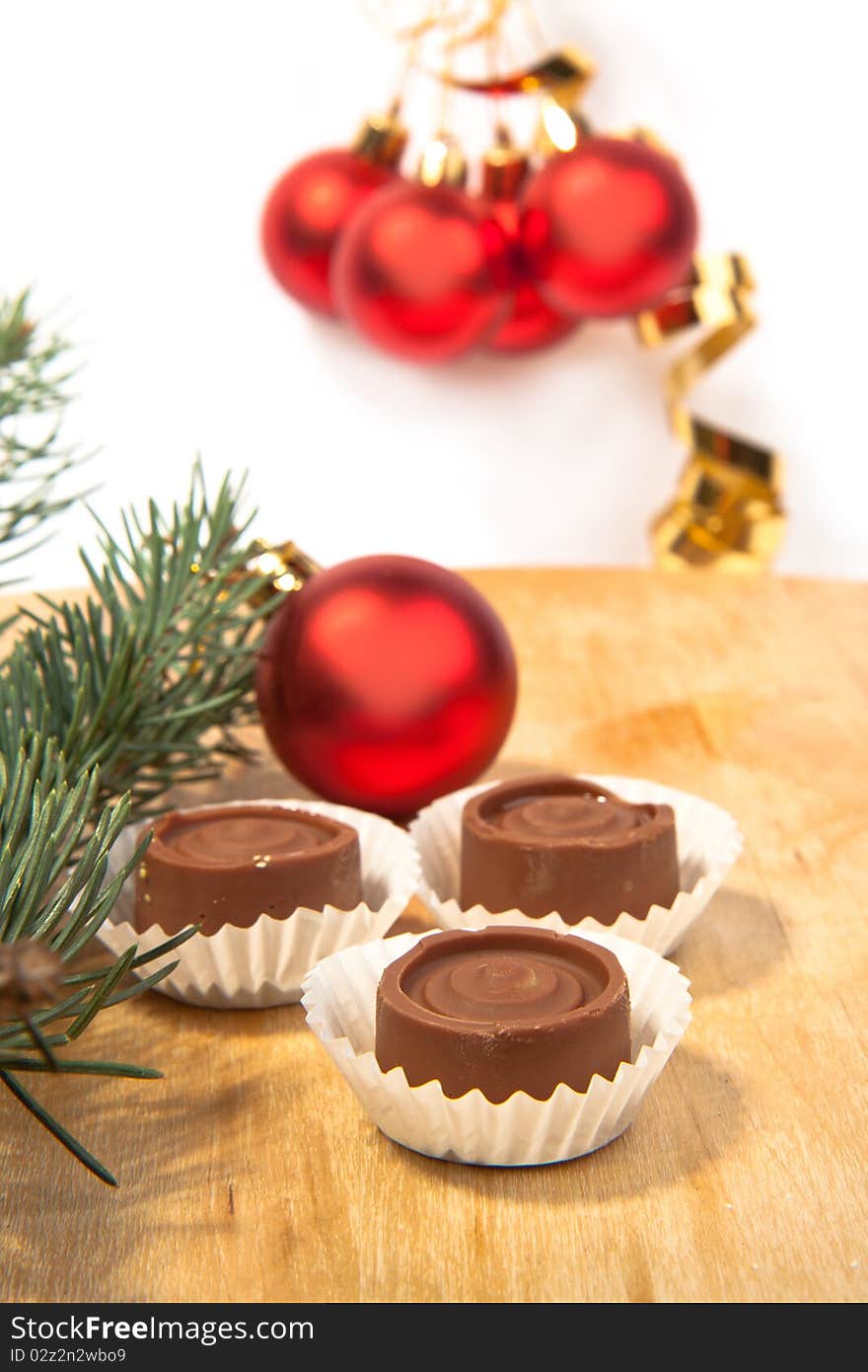 Red christmas balls with a homemade chocolate and christmas tree. Red christmas balls with a homemade chocolate and christmas tree