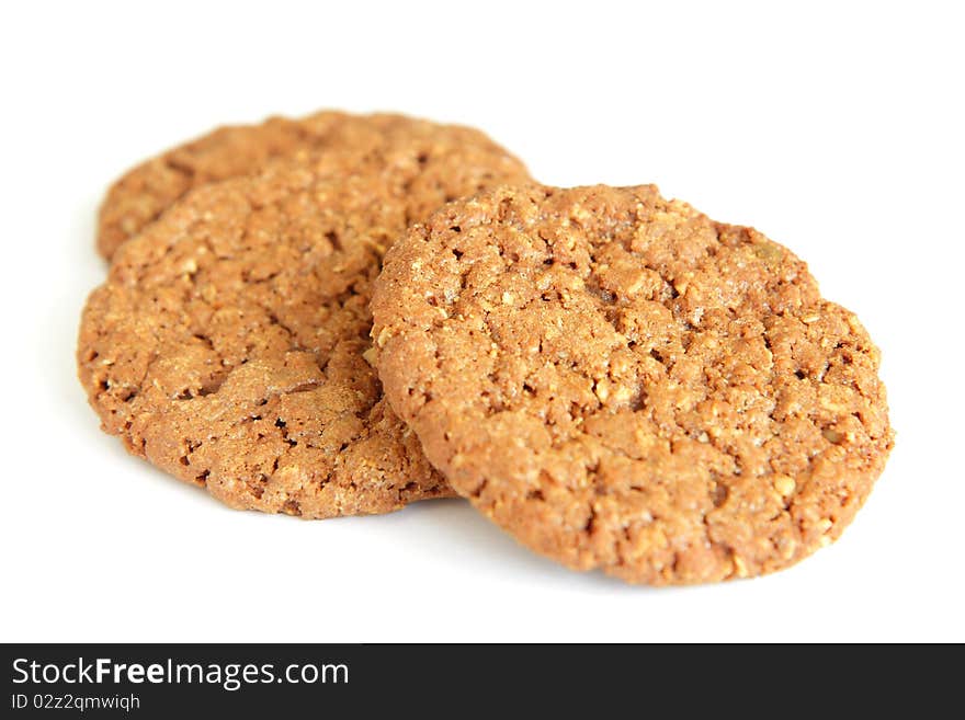 Three oatmeal cookies with chocolate