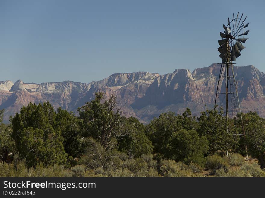 The windmill on Gooseberry Mesa's well known windmill loop, a popular mountain biking destination. Zions National Park in the background.