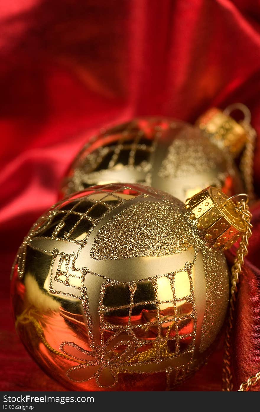 Shiny gold baubles with red background material. Shiny gold baubles with red background material