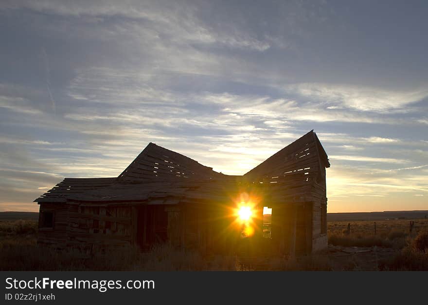 One of the few remaining structures built by the early settlers of the Short Creek valley in northern Arizona. the setting sun is shining thru the open doorway. One of the few remaining structures built by the early settlers of the Short Creek valley in northern Arizona. the setting sun is shining thru the open doorway.