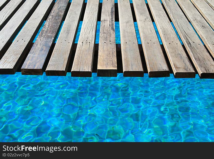 The wooden bridge in a swimming pool. The wooden bridge in a swimming pool