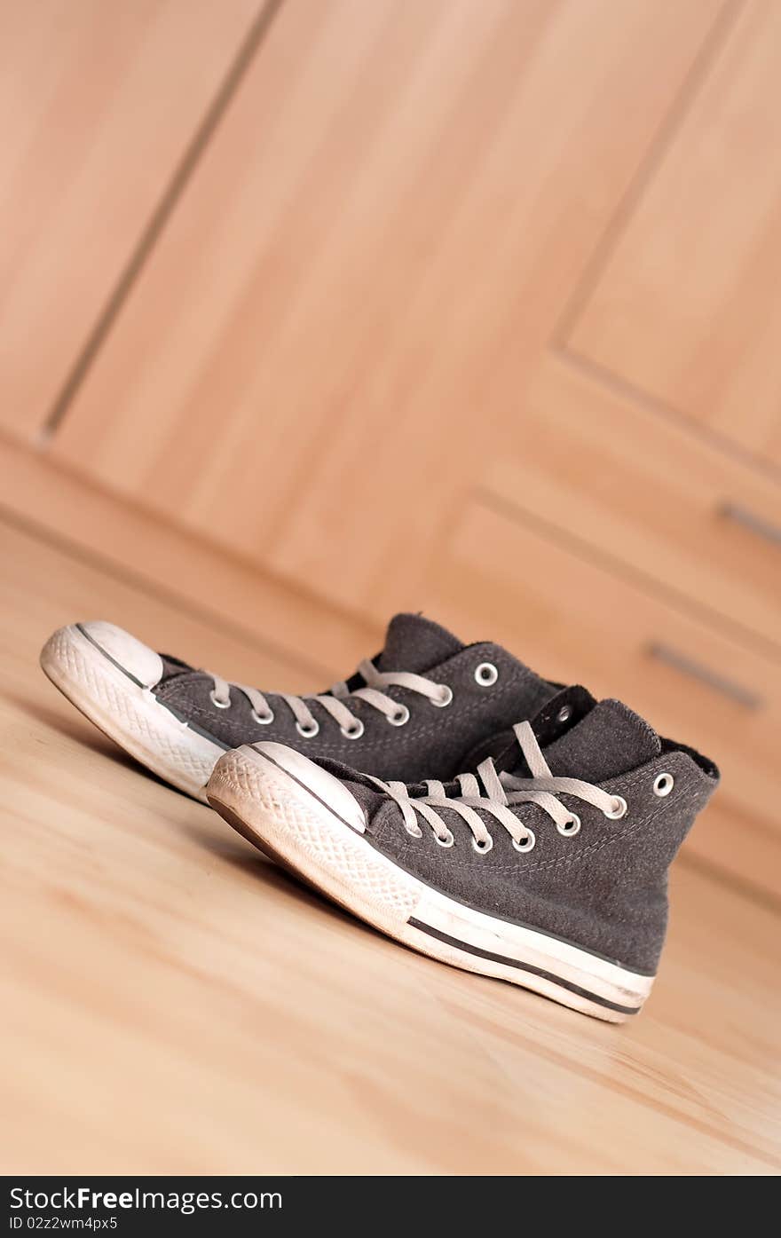 Grey vintage sneakers on the floor