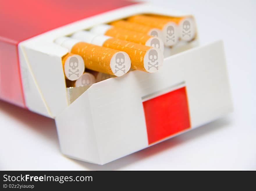 Cigarettes in box marked with skull and bones sign