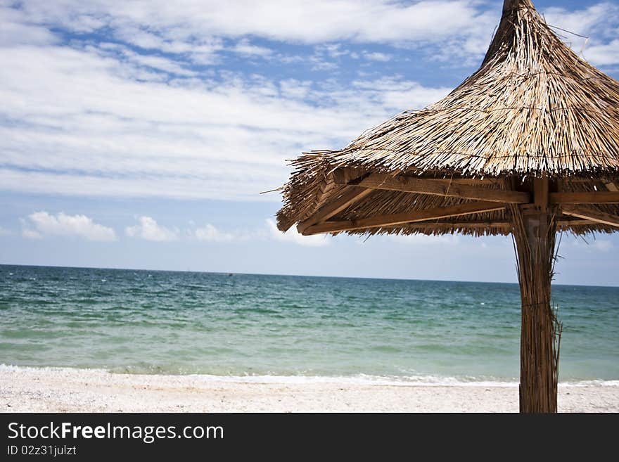 A thatch umbrella on the beach. A thatch umbrella on the beach