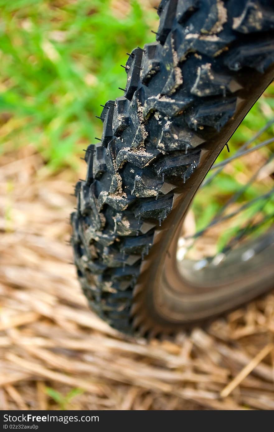 Dirty bike wheel on the ground, closeup