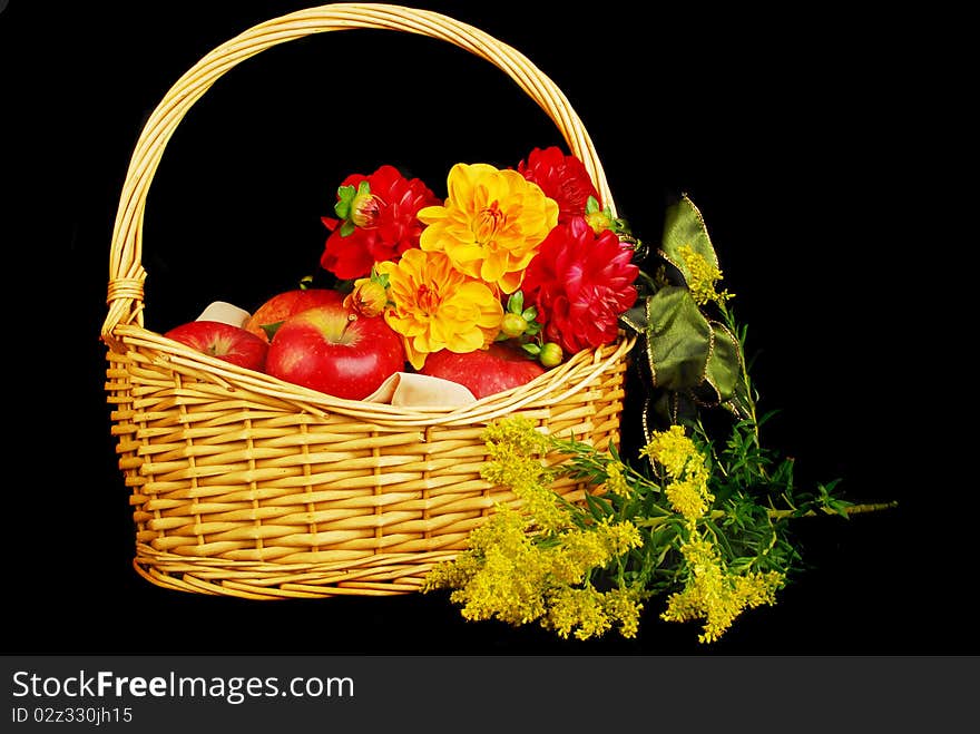 Autumn Basket with red apples and flowers isolated on the black background. Autumn Basket with red apples and flowers isolated on the black background.