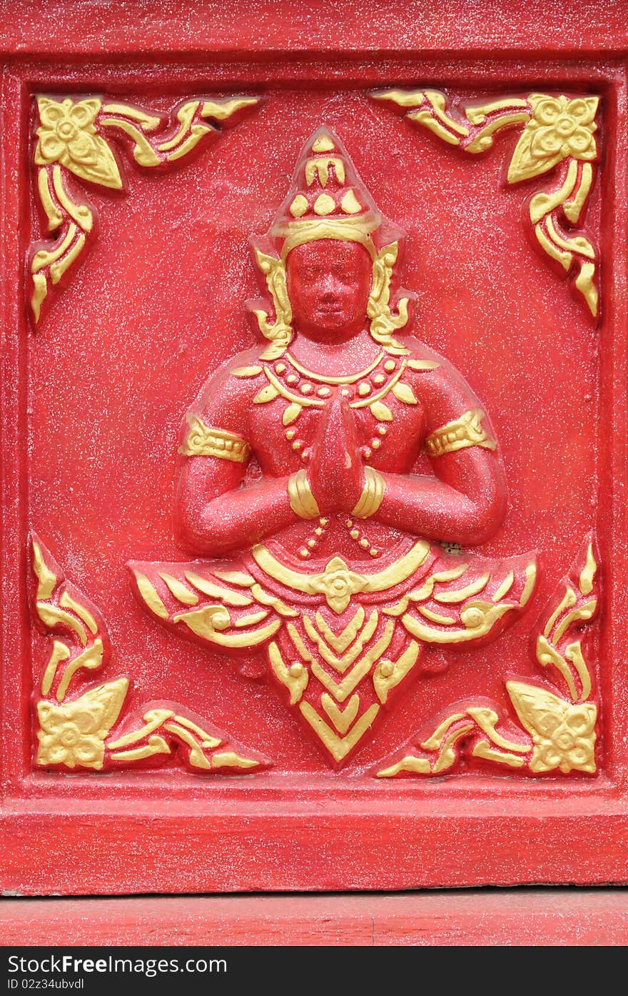 Details of traditional Thai art on base of church.