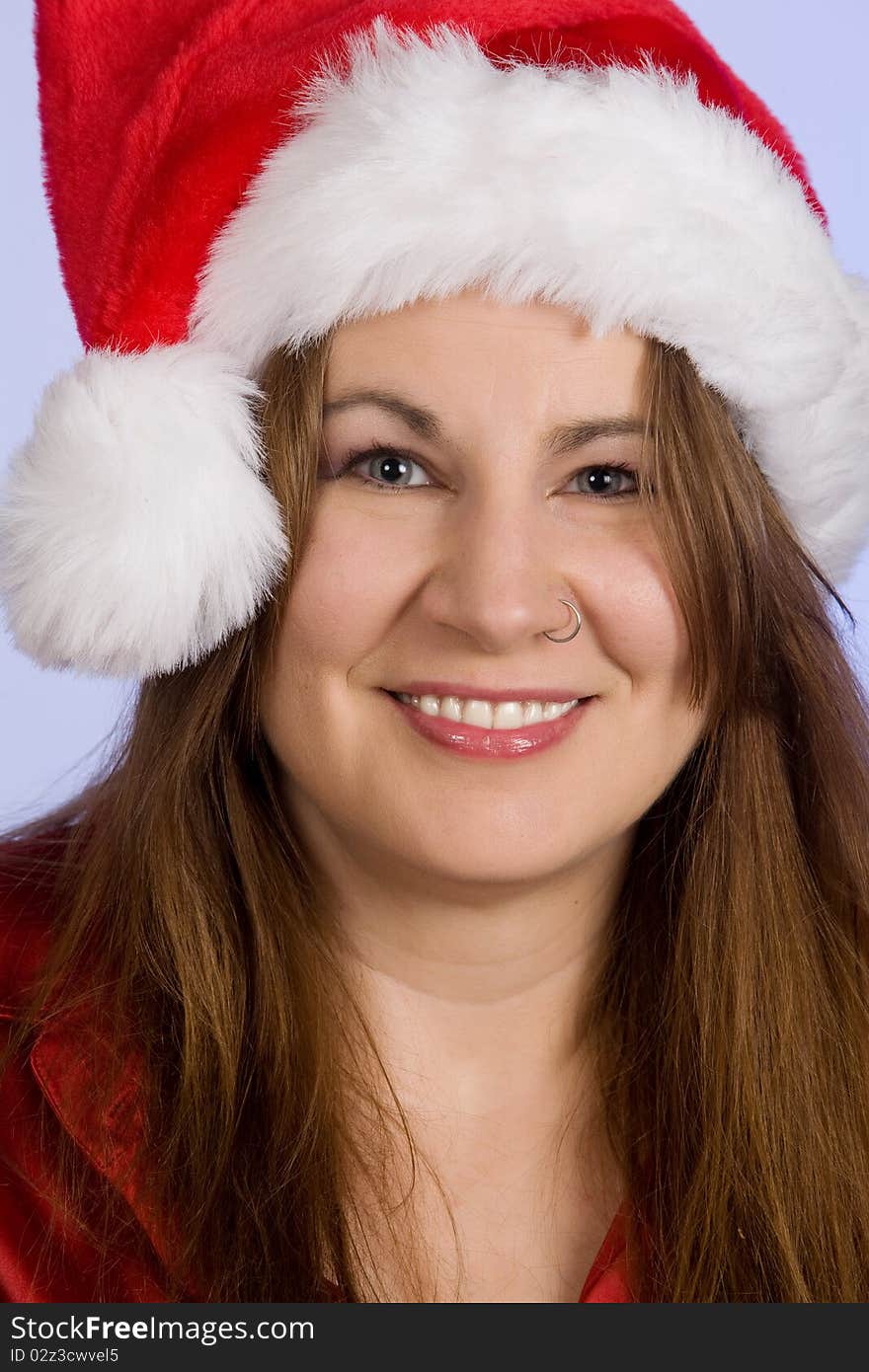 A woman in her forties wearing Santa hat. A woman in her forties wearing Santa hat