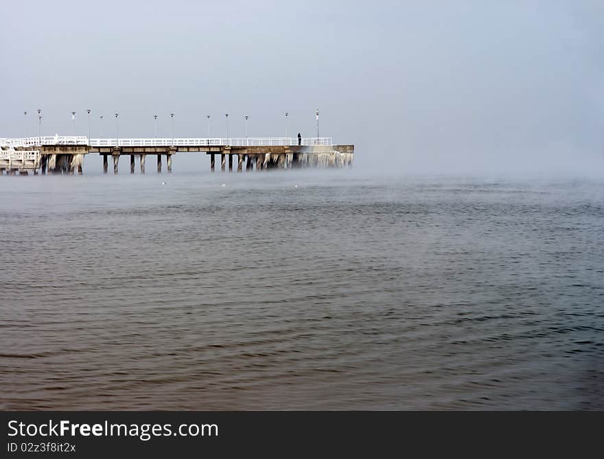 Frozen pier, lonely man