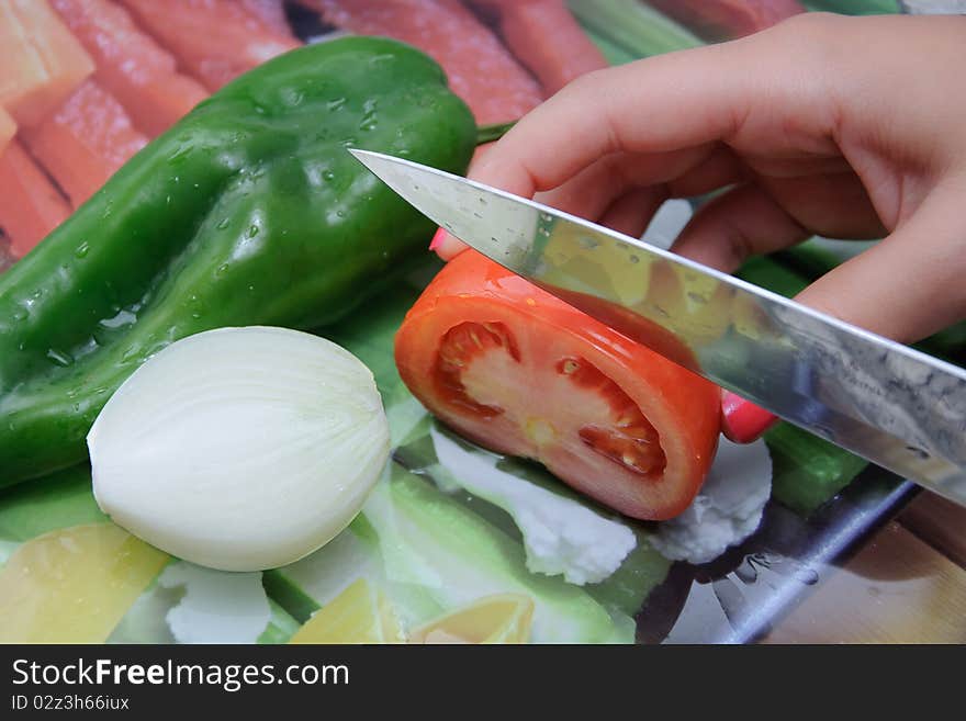 Fresh vegetables on a cut table. Tomato, onion and pepper